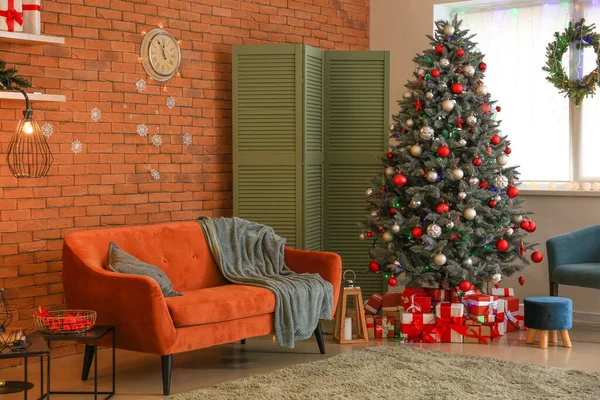 Interior of room with Christmas tree and sofa