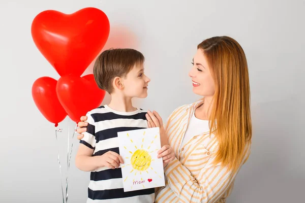 Little Boy Greeting His Mother Light Background — Stock Photo, Image