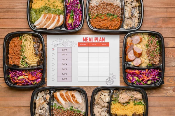 Containers with healthy food and meal plan on wooden background