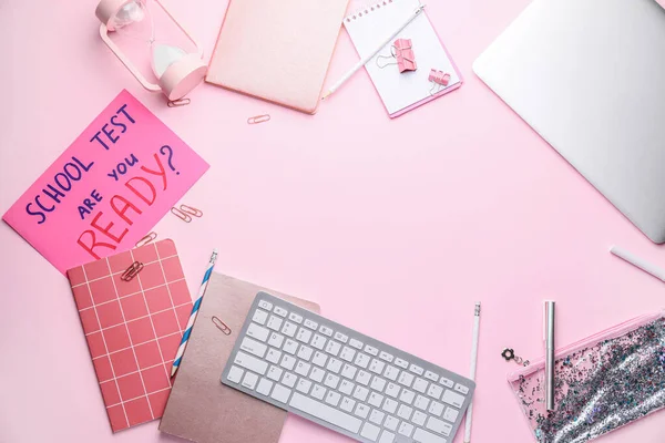 Stationery, laptop, computer keyboard and paper sheet with text SCHOOL TEST, ARE YOU READY? on color background