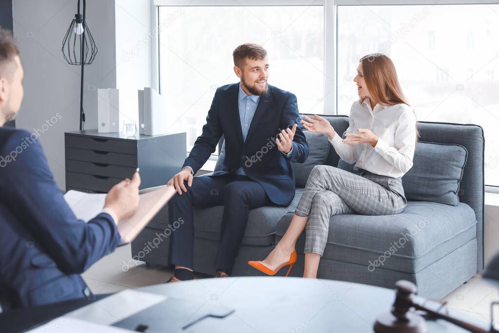 Stressed couple visiting lawyer in office