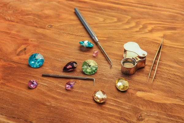 Gemstones and tools on table of jeweller