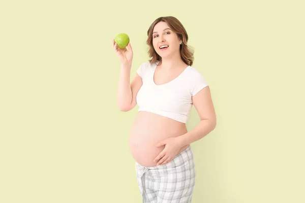 Hermosa Mujer Embarazada Con Manzana Sobre Fondo Color —  Fotos de Stock