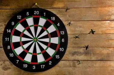 Ahşap zemin üzerinde dart tahtası olan oklar