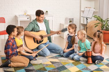Teacher giving music lessons at school
