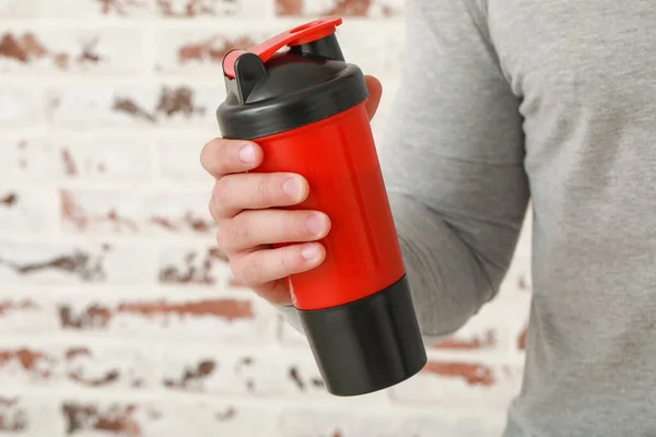 Sporty Man Protein Shake Brick Background Closeup — Stock Photo, Image