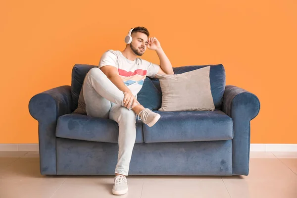 Young Man Listening Music While Sitting Sofa Home — Stock Photo, Image