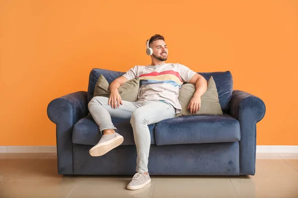 Young Man Listening Music While Sitting Sofa Home — Stock Photo, Image
