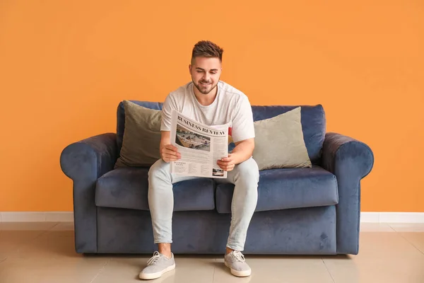 Young Man Reading Newspaper While Sitting Sofa Home — Stock Photo, Image