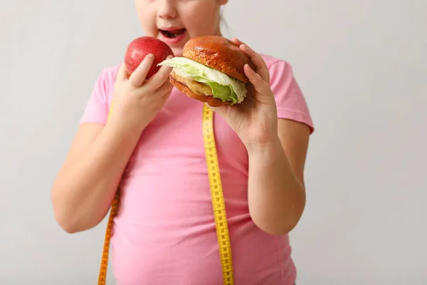 Übergewichtiges Mädchen Mit Gesundem Und Ungesundem Essen Auf Hellem Hintergrund — Stockfoto