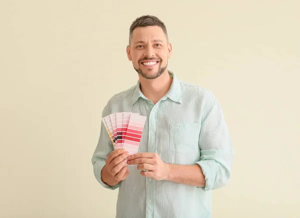 Man with color palettes on light background