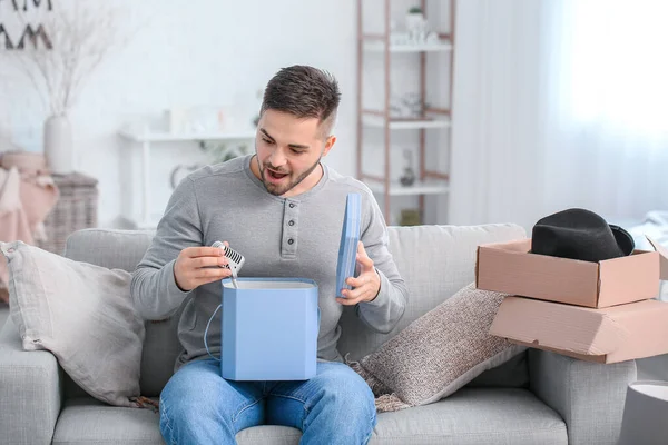 Surprised Young Man Unpacking Box Microphone Home — Stock Photo, Image