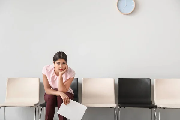 Young woman waiting for job interview indoors