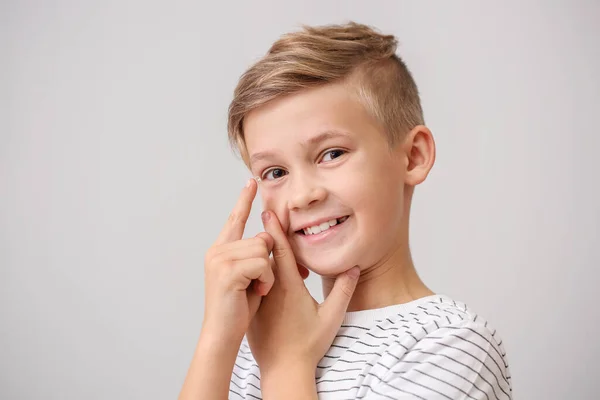 Little Boy Putting Contact Lens Grey Background — Stock Photo, Image