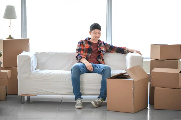 Asian Man Belongings Sitting Sofa His New Flat — Stock Photo, Image