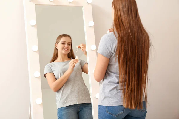 Beautiful Young Woman Applying Face Serum Front Mirror Home — Stock Photo, Image