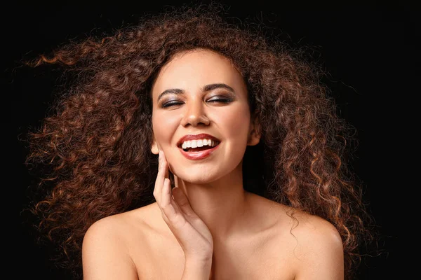 Beautiful African-American woman on dark background