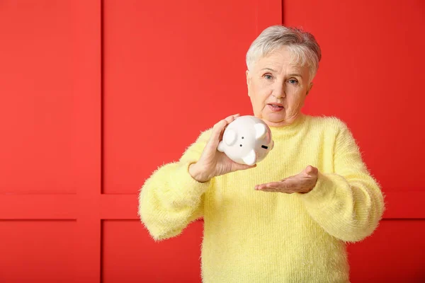 Sad Senior Woman Empty Piggy Bank Color Background — Stock Photo, Image