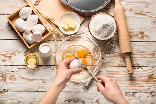 Woman preparing bakery at table, top view