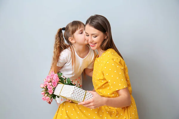 Little Daughter Greeting Her Mother Grey Background — Stock Photo, Image
