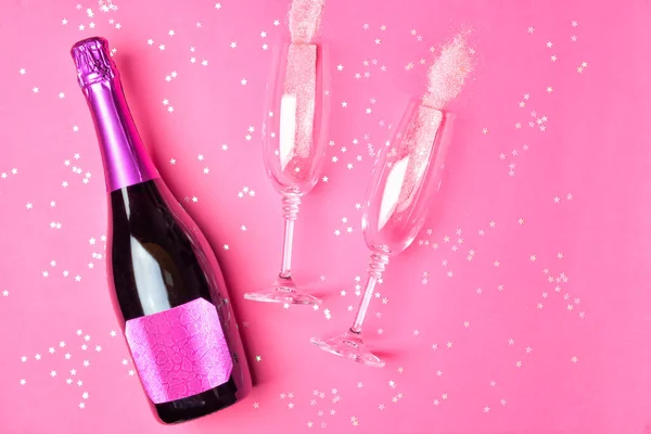 Bottle of tasty champagne and glasses on color background