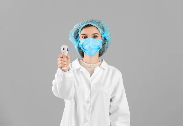 Female Doctor Protective Mask Thermometer Grey Background Concept Epidemic — Stock Photo, Image