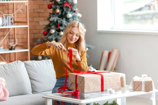 Beautiful Young Woman Wrapping Christmas Gifts Home — Stock Photo, Image