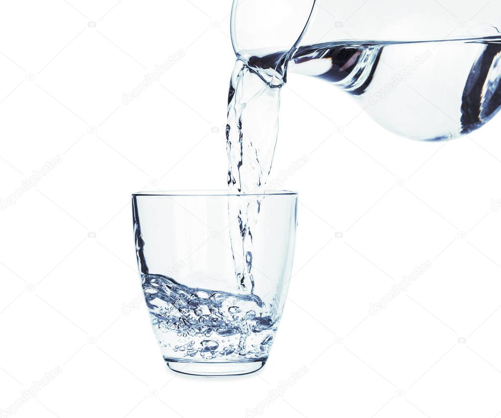 Pouring of fresh water in glass on white background