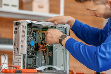 Electronic technician repairing computer in service center