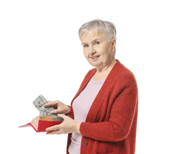 Senior woman with wallet and money on white background