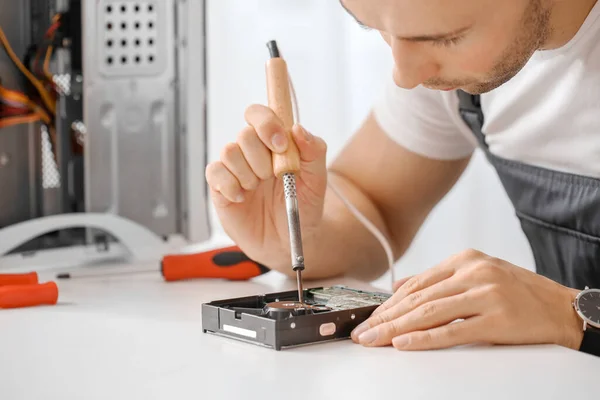 Electronic technician repairing computer in service center