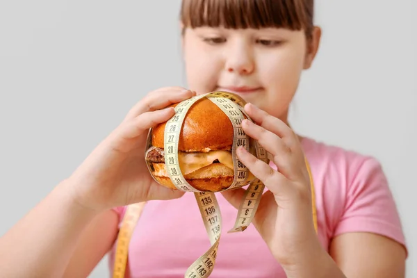 Overweight Girl Unhealthy Burger Measuring Tape Light Background — Stock Photo, Image