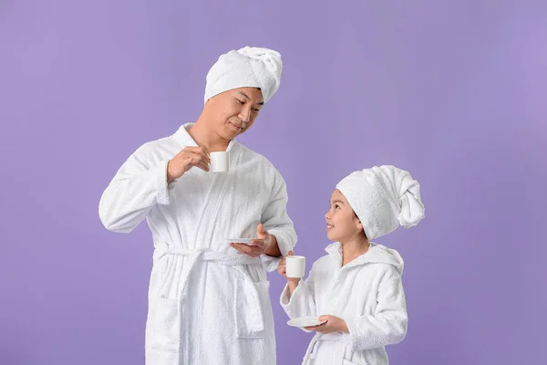 Asian Man His Little Daughter Bathrobes Drinking Tea Color Background — Stock Photo, Image