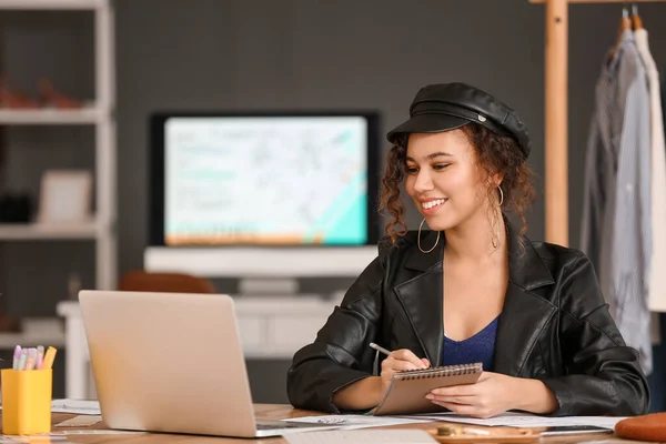 Female clothes stylist working in office