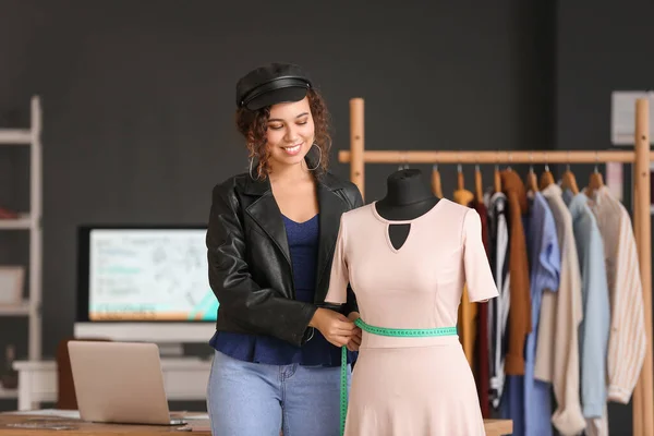 Female clothes stylist working in office