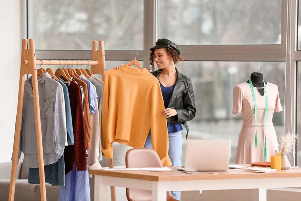 Female clothes stylist working in office