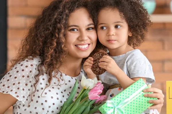 African-American woman with gift for Mother\'s Day received from her little daughter at home