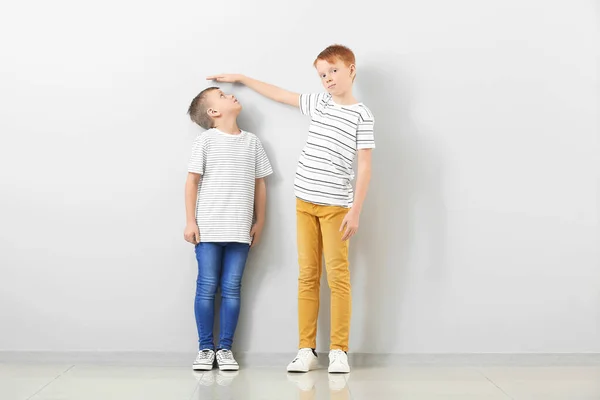 Cute Little Boys Measuring Height Light Wall — Stock Photo, Image