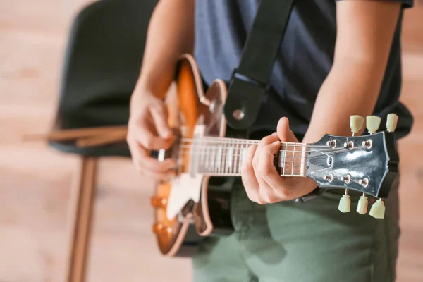 Young Man Playing Guitar Wooden Wall Closeup — Stock Photo, Image