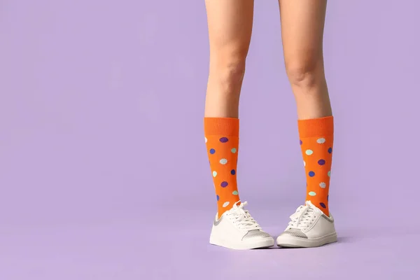 穿着袜子和鞋子的年轻女子的腿 有彩色背景 — 图库照片