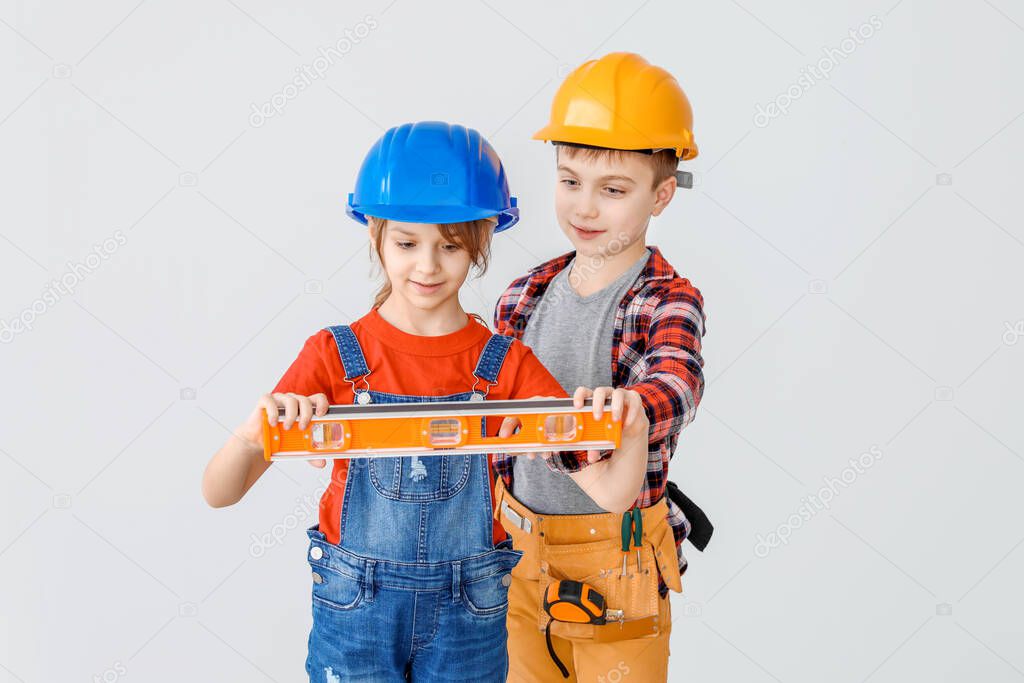 Cute little architects on light background