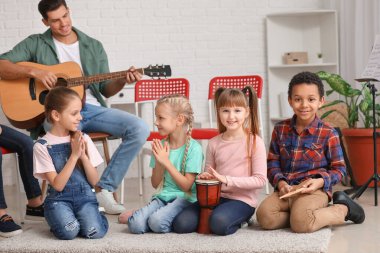 Teacher giving music lessons at school
