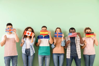 Young students of language school on color background clipart