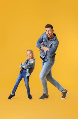 Mutlu bir adam ve küçük kızı renkli arka planda dans ediyorlar