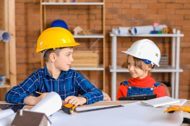 Cute little architects in office