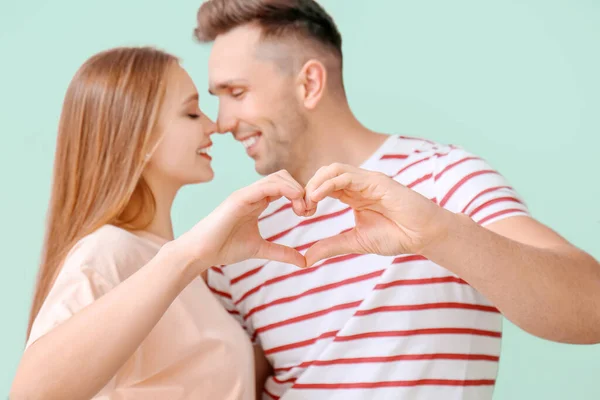 Happy Young Couple Making Heart Hands Color Background — Stock Photo, Image