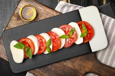 Domatesli Mozzarella peyniri, fesleğen ve yağ.