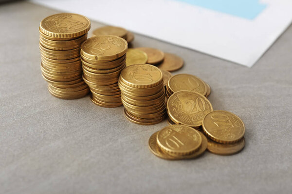 Many golden coins on table