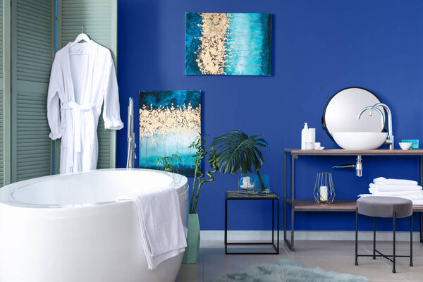Interior of modern bathroom with blue wall