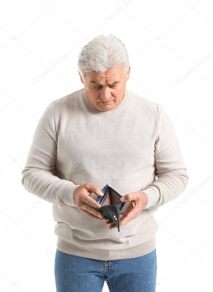 Sad senior man with empty purse on white background